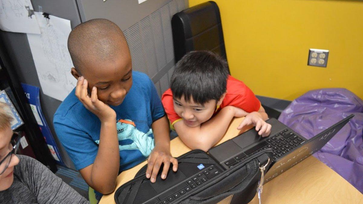 two boys working on Chromebook