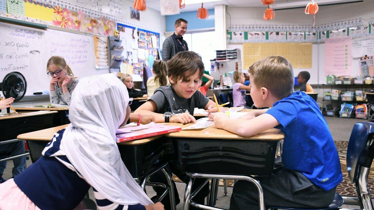 Three students work together on a project